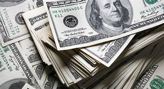 stack of one hundred dollars notes on dollars background