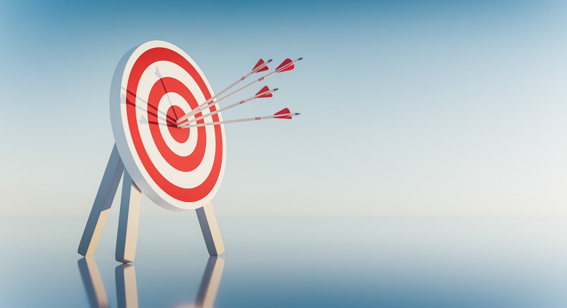 Dartboard with multiple arrows hitting the bullseye