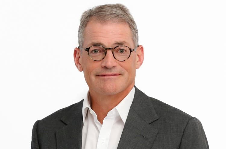 Michael Fisch in gray suit against a white background