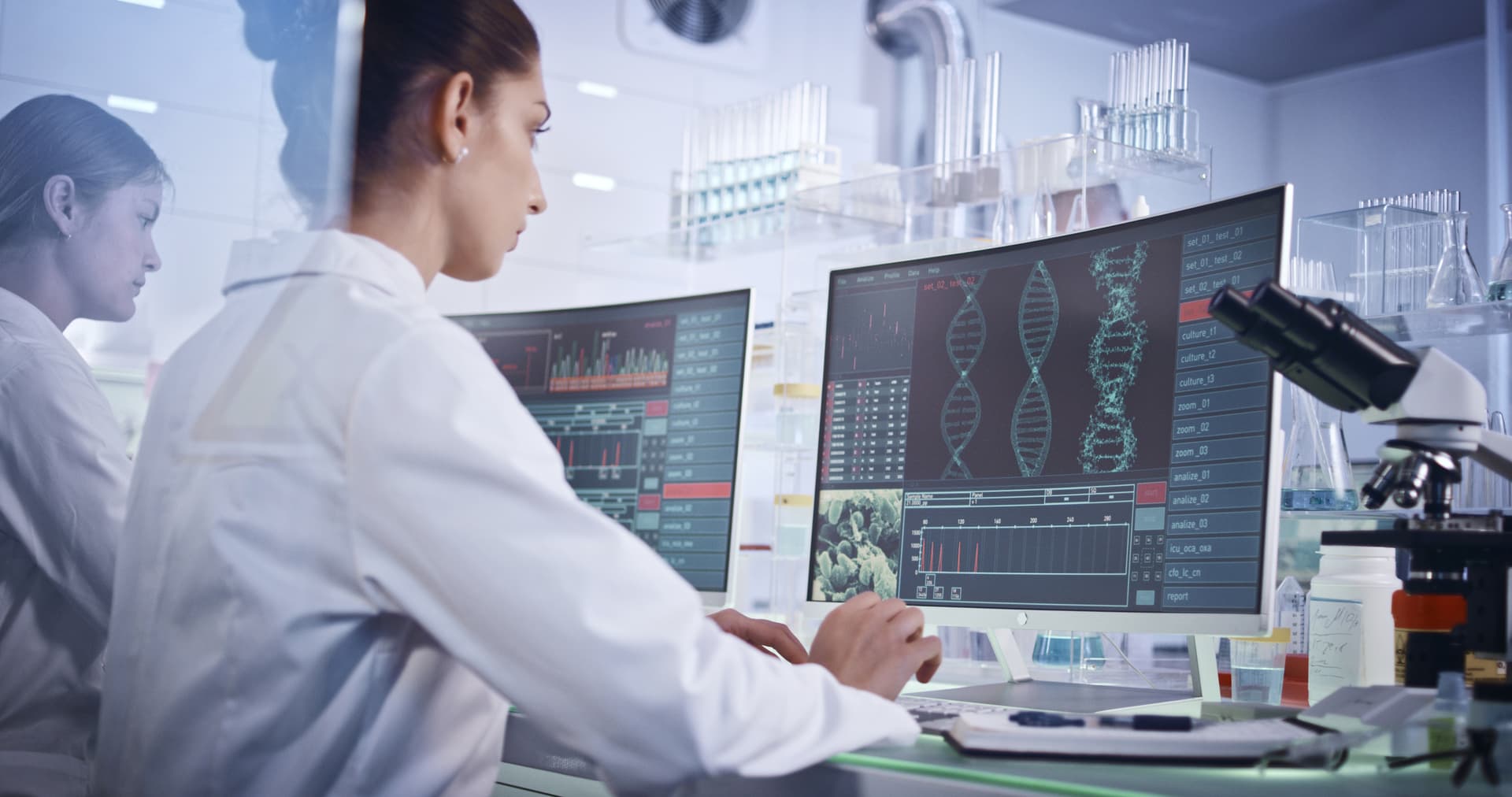 Scientists examines DNA models in genetic research laboratory.