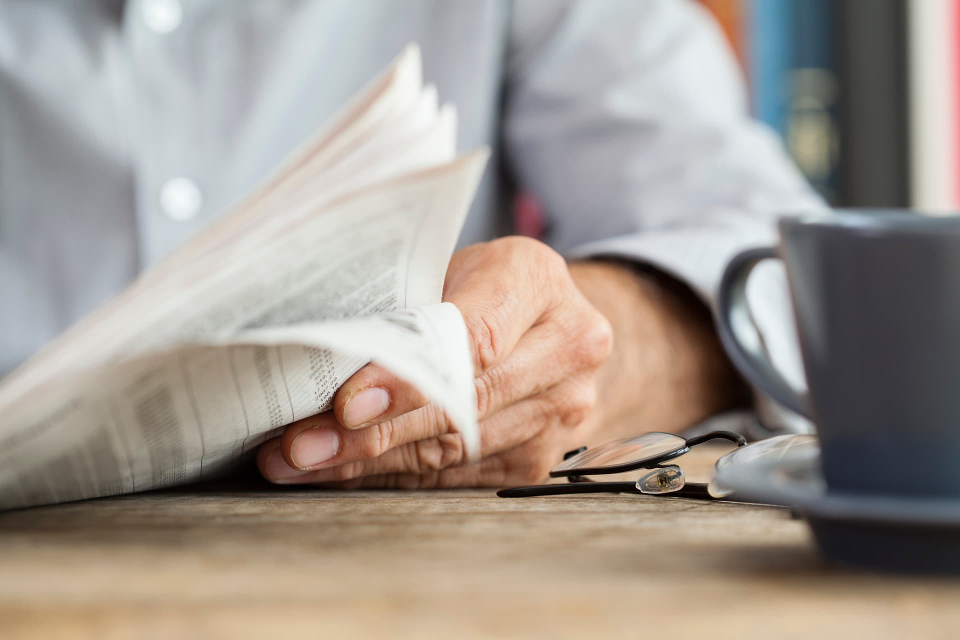 Man paper reading on table