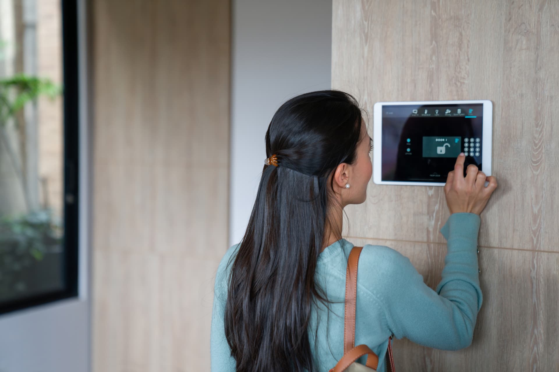 Woman using a home automation system - smart homes concepts.