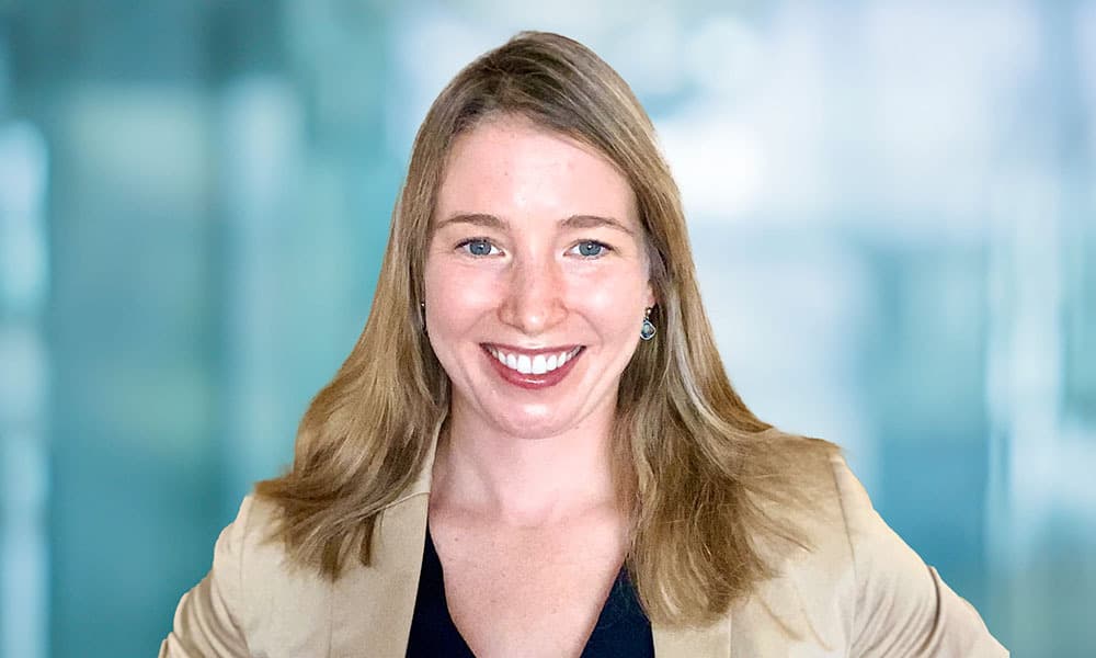 headshot of Jennifer Roach, Yellow Wood Partners, against a light blue background