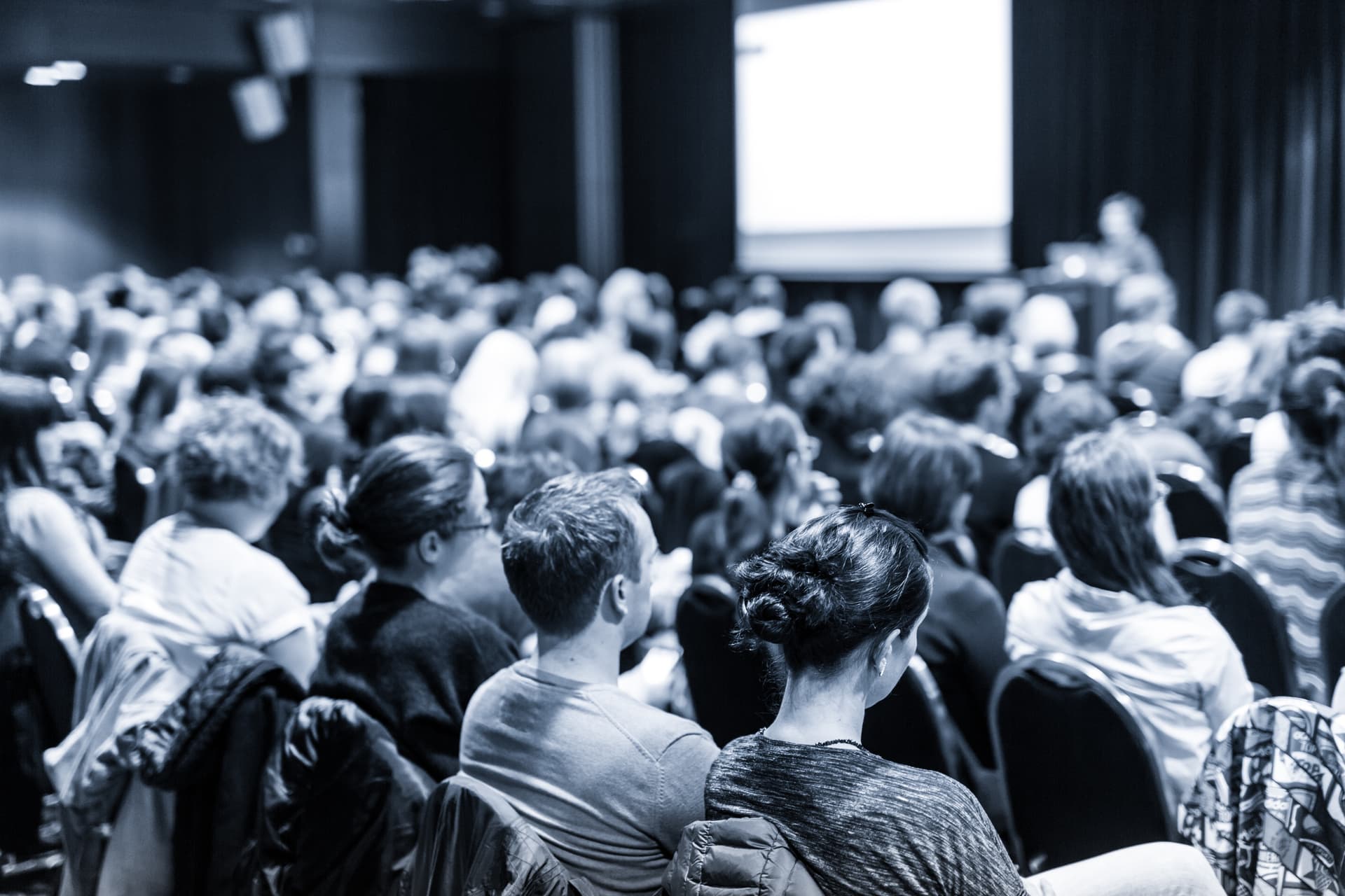 Speaker giving presentation at a business conference.