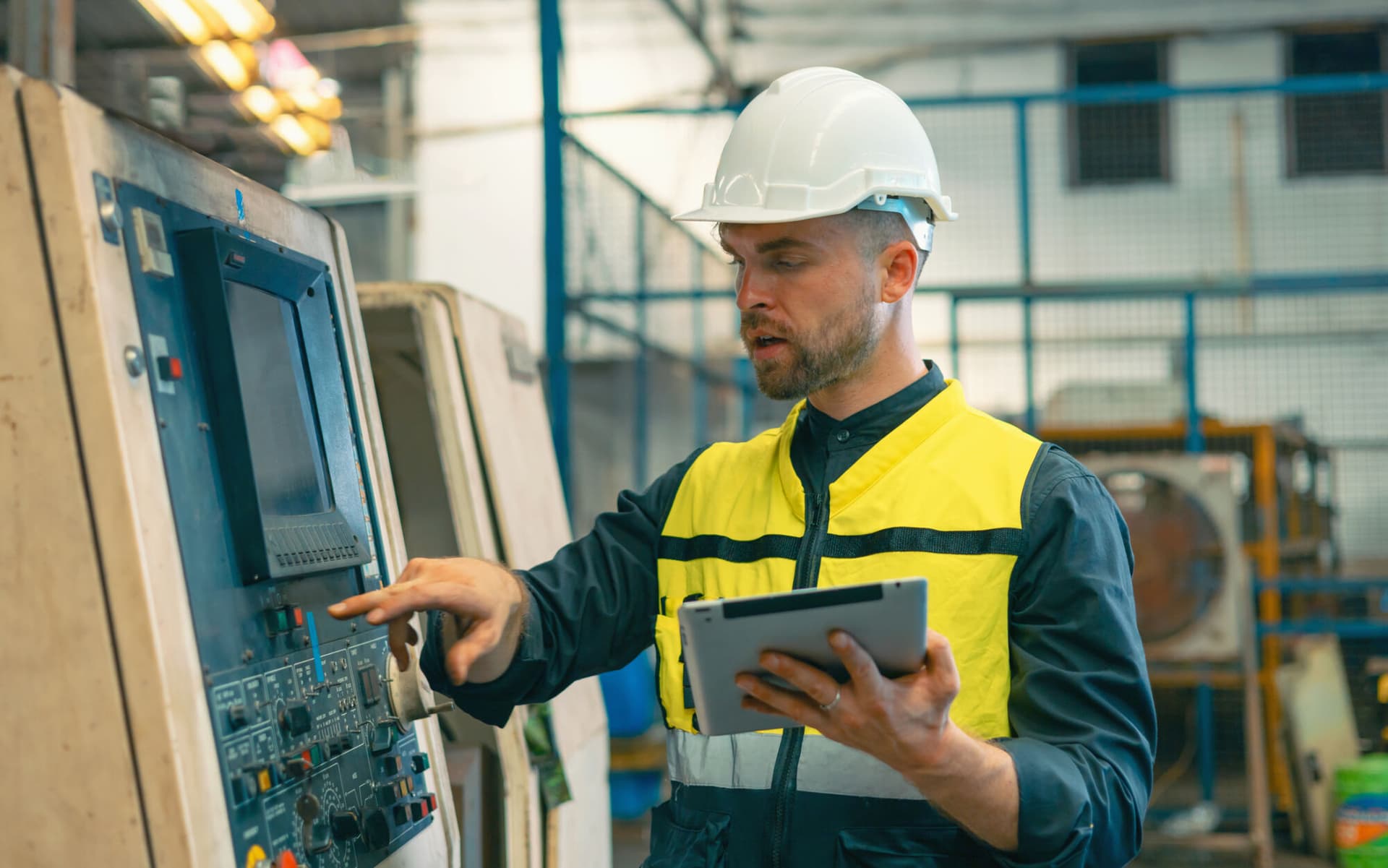 Worker and engineer using tablet computer for inspection and checking production process on factory station.