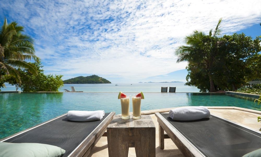 Lounge chairs by a pool in a resort