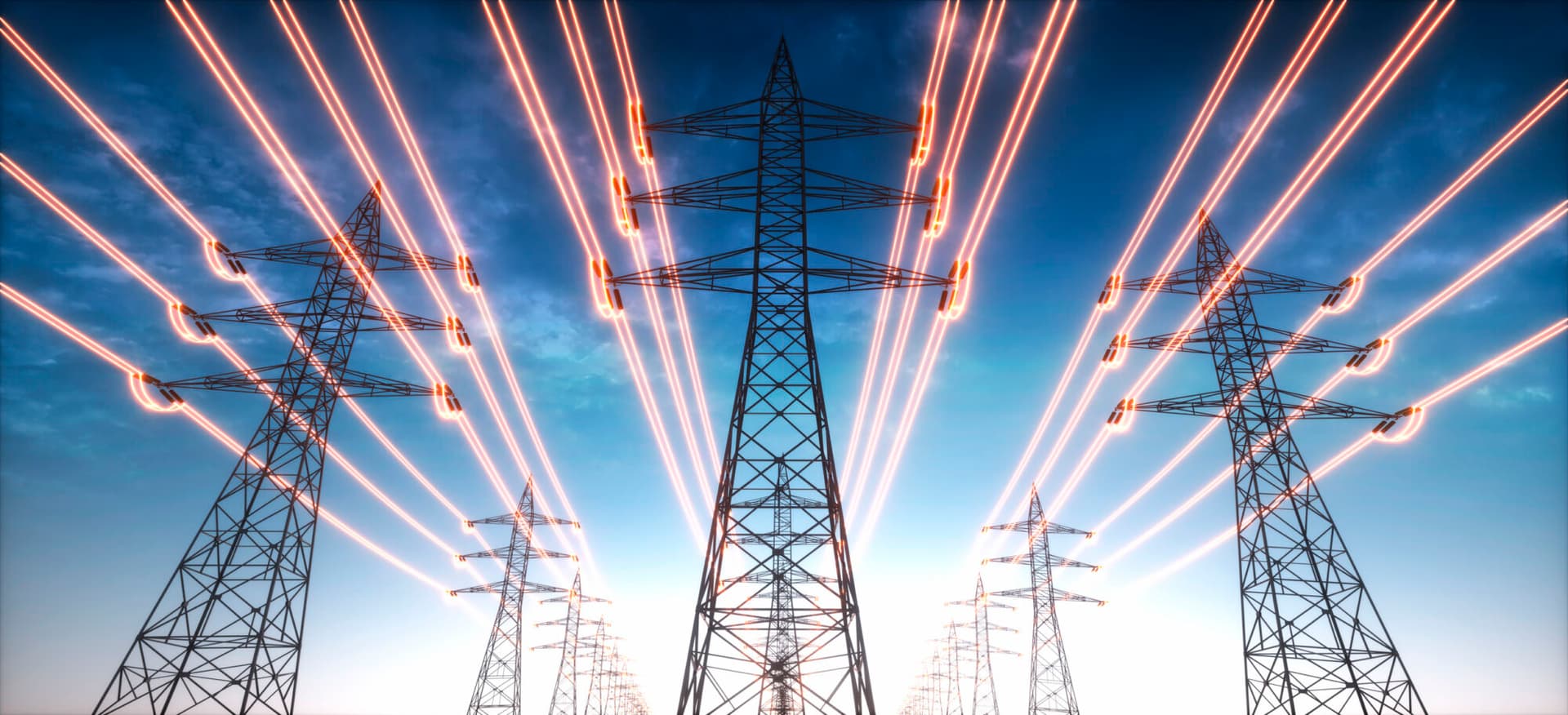 High voltage transmission towers with red glowing wires against blue sky. (Getty Images)