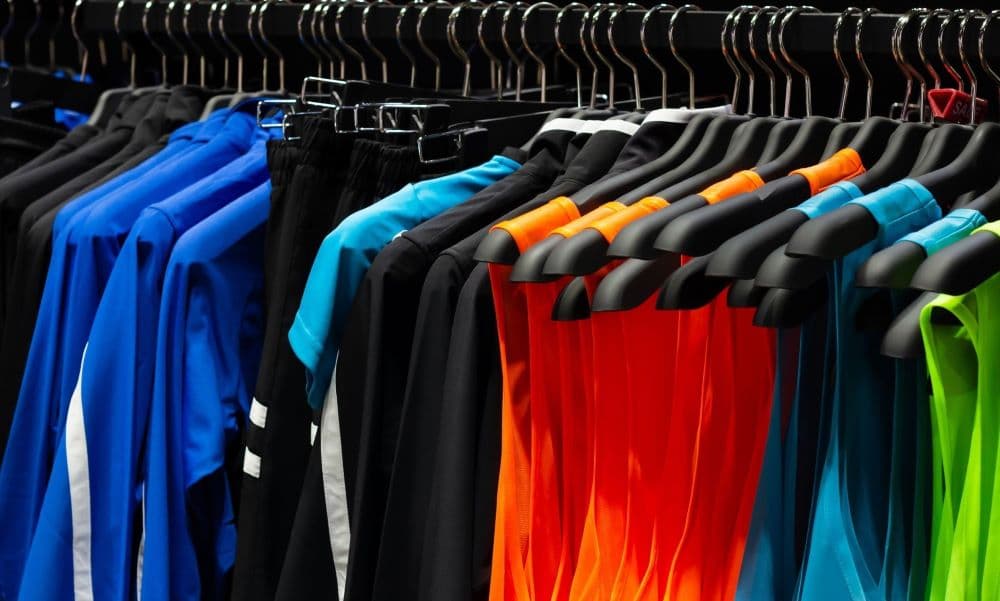 Picture of athletic and sports apparel hanging up on a rack.