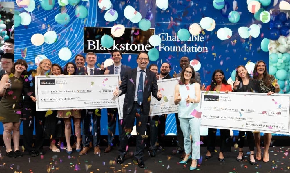 Blackstone's Jon Gray with the winners and runner-ups in the Blackstone Gives Back challenge.