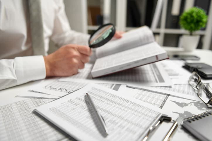 Businessman working at office and calculating finance, reads and writes reports. Business financial accounting concept.