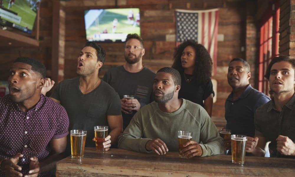 Patrons at a bar watching sports, specifically football.