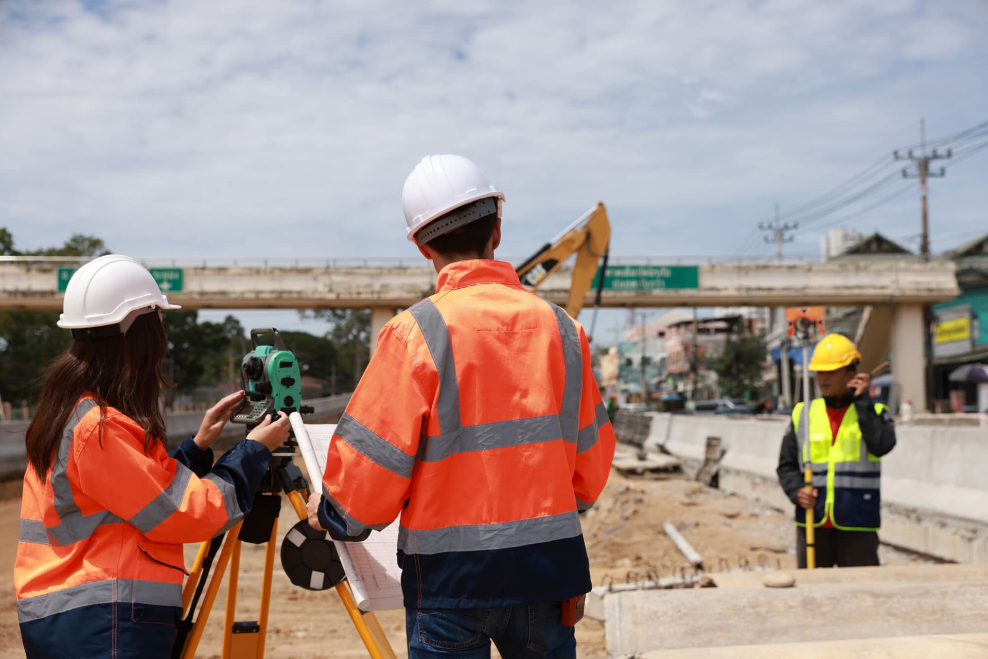 Construction engineer talking to architect at industrial construction site in road construction site (Getty)