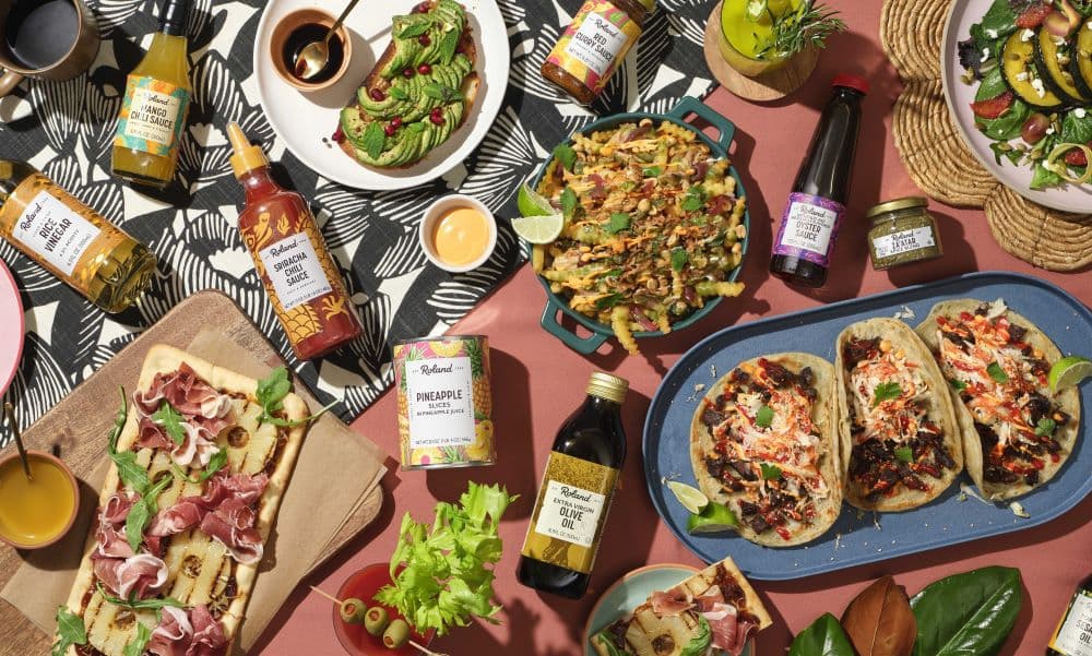 Image of a spread of tacos and other foods with Roland Foods products.