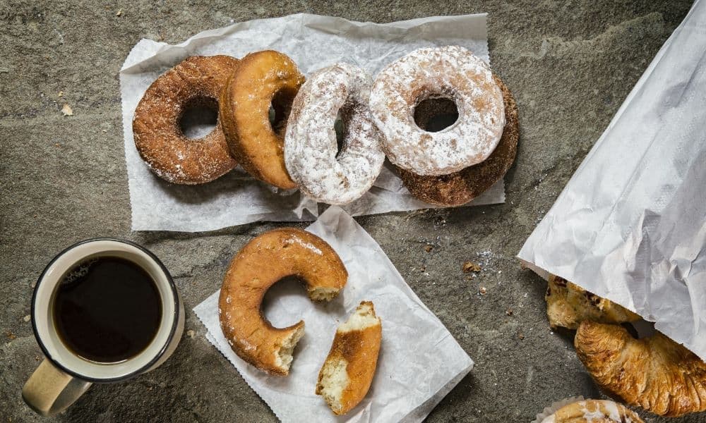 A picture of some doughnuts and coffee.