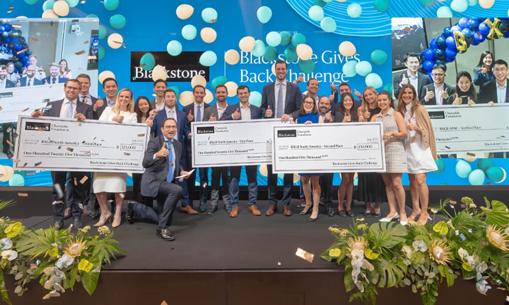 Blackstone's Jonathan Gray with winners and runner-ups of Blackstone Gives Back Challenge.