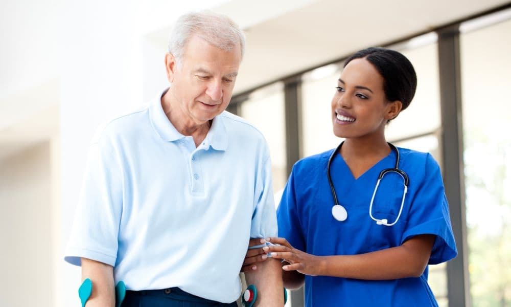 A picture of a nurse helping an elderly patient.