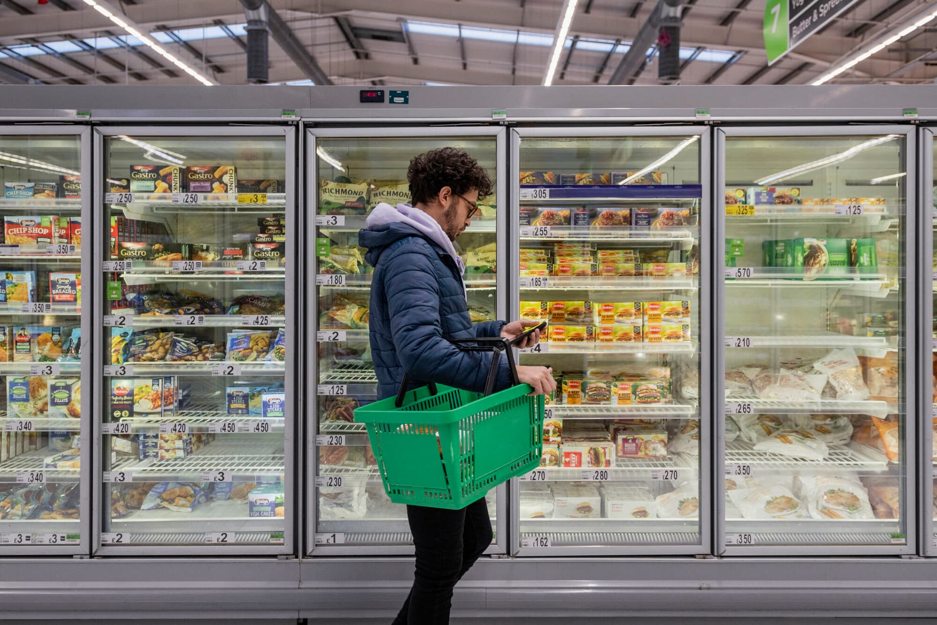 Photograph of a man shopping in a grocery store.