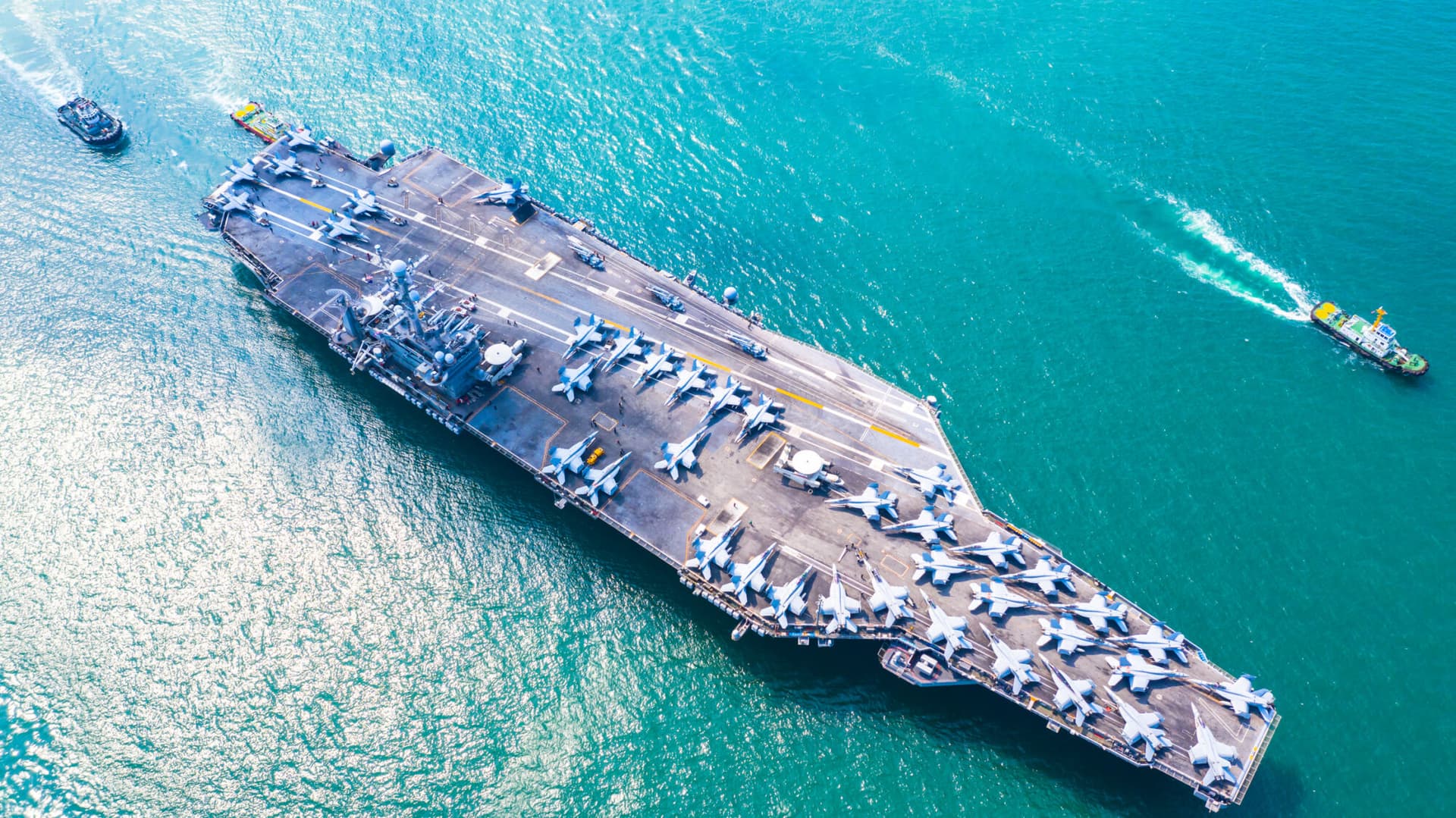 Image of a military navy nuclear aircraft carrier, Military navy ship carrier full loading fighter jet aircraft.