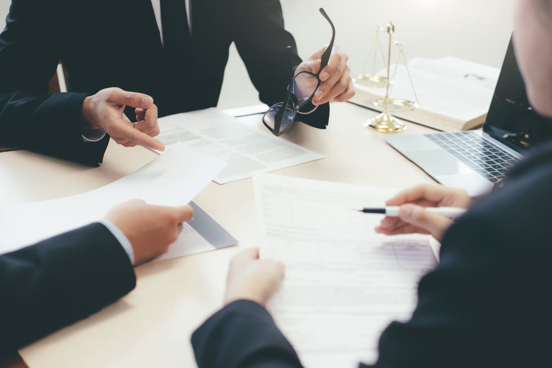 A group of people sitting around a table discussing legal matters