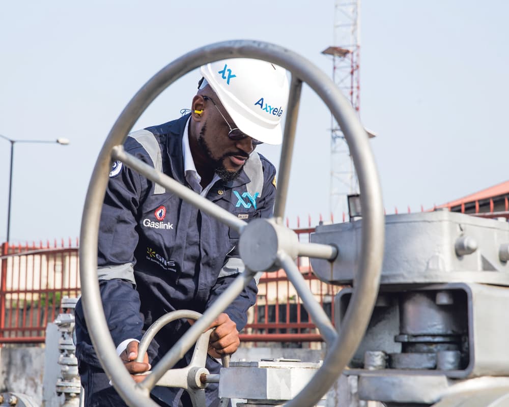 Axxela: A worker operating a pump