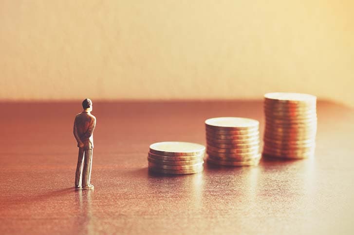 Miniature people looking future with stack coin about financial and money savings concept.