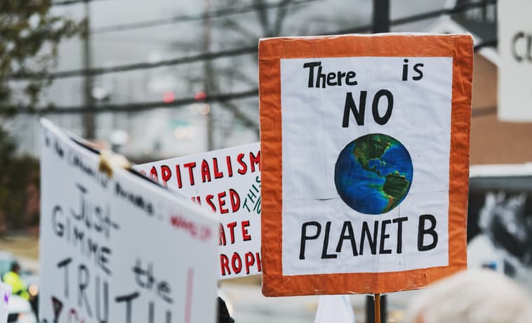 Climate change protestors hold their placards high.