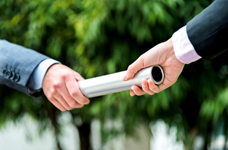 Business people passing baton