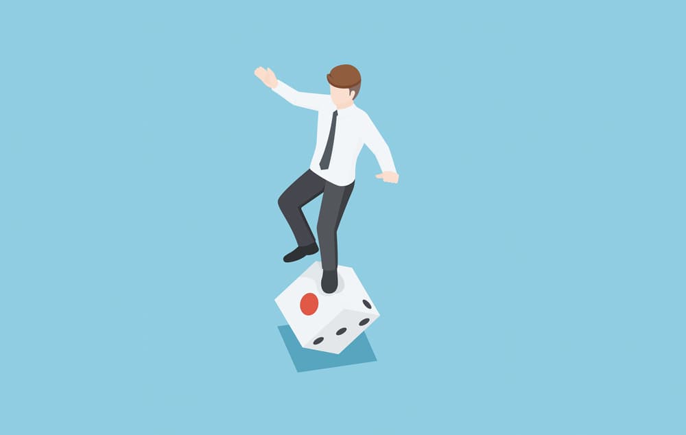 Illustration of a man balancing on a dice