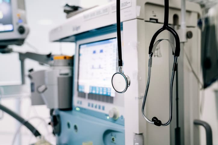 Stethoscope next to medical ventilator in emergency room.