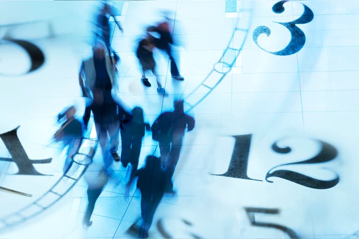 Blurred pedestrians on clock face
