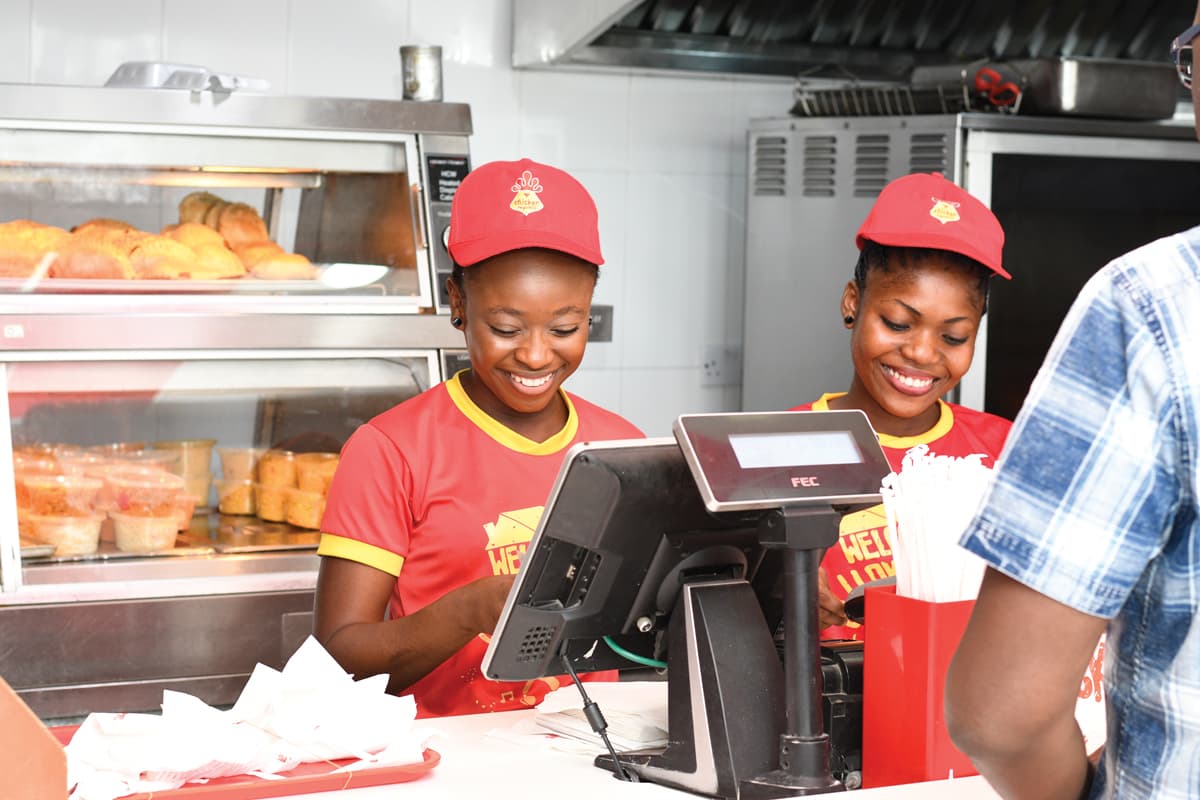 Staff working behind the counter of a fast food restaurant