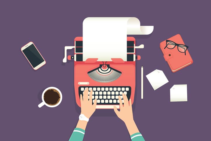 Woman’s hands typing on a vintage typewriter