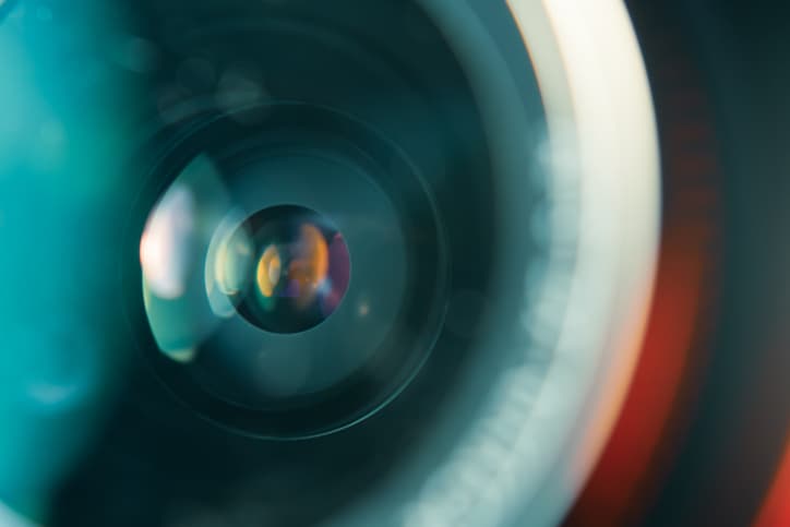 Camera lens in colorful light focus