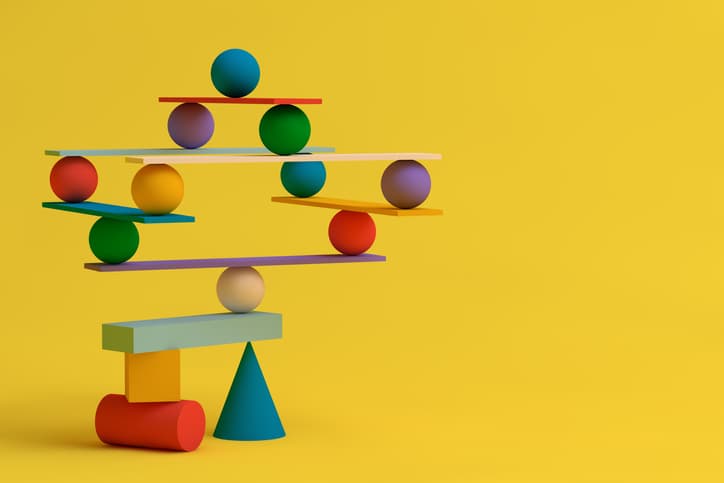 Several balancing geometric shapes, symbiosis, collaboration