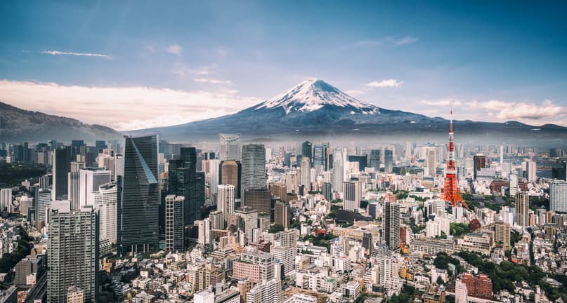 View of Mt. Fuji, Tokyo Tower and crowded buildings in downtown Tokyo.