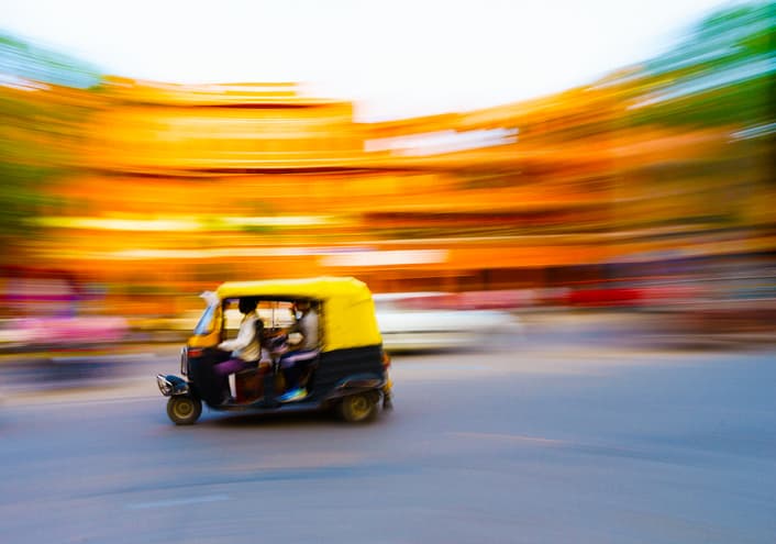A rickshaw taxi driving through Mumbai, India