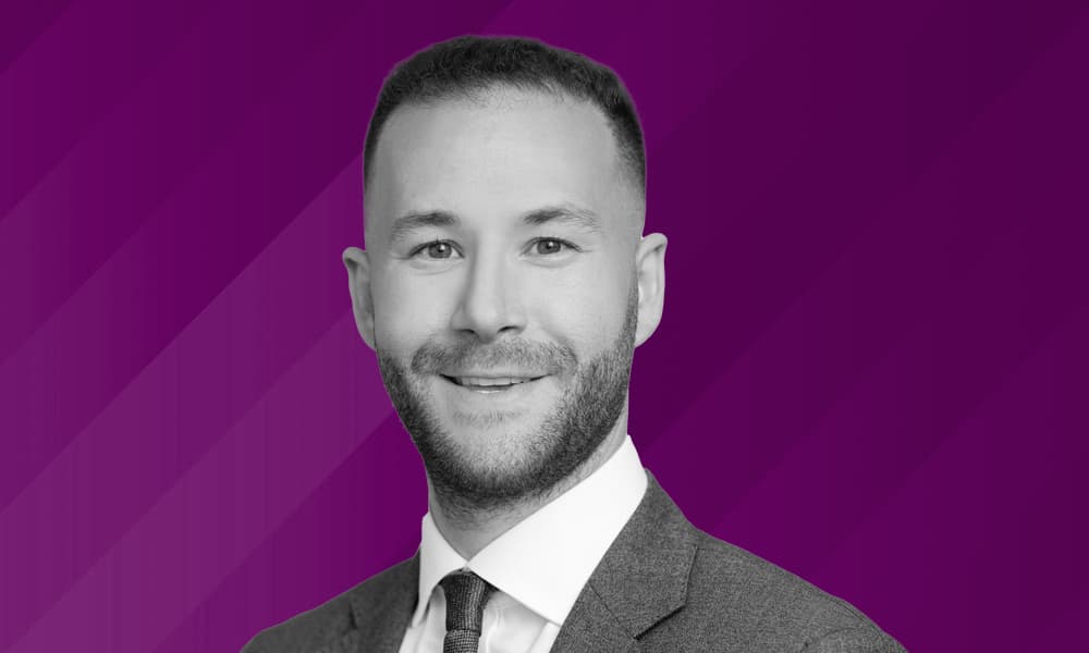 Headshot of Michael Ostro, UBP, against a purple background