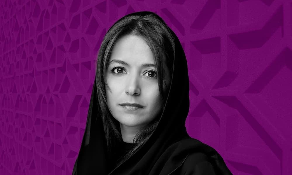 Headshot of Huda Al Lawati against a purple background