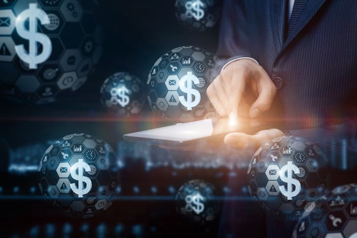 Businessman working with electronic money on a tablet.