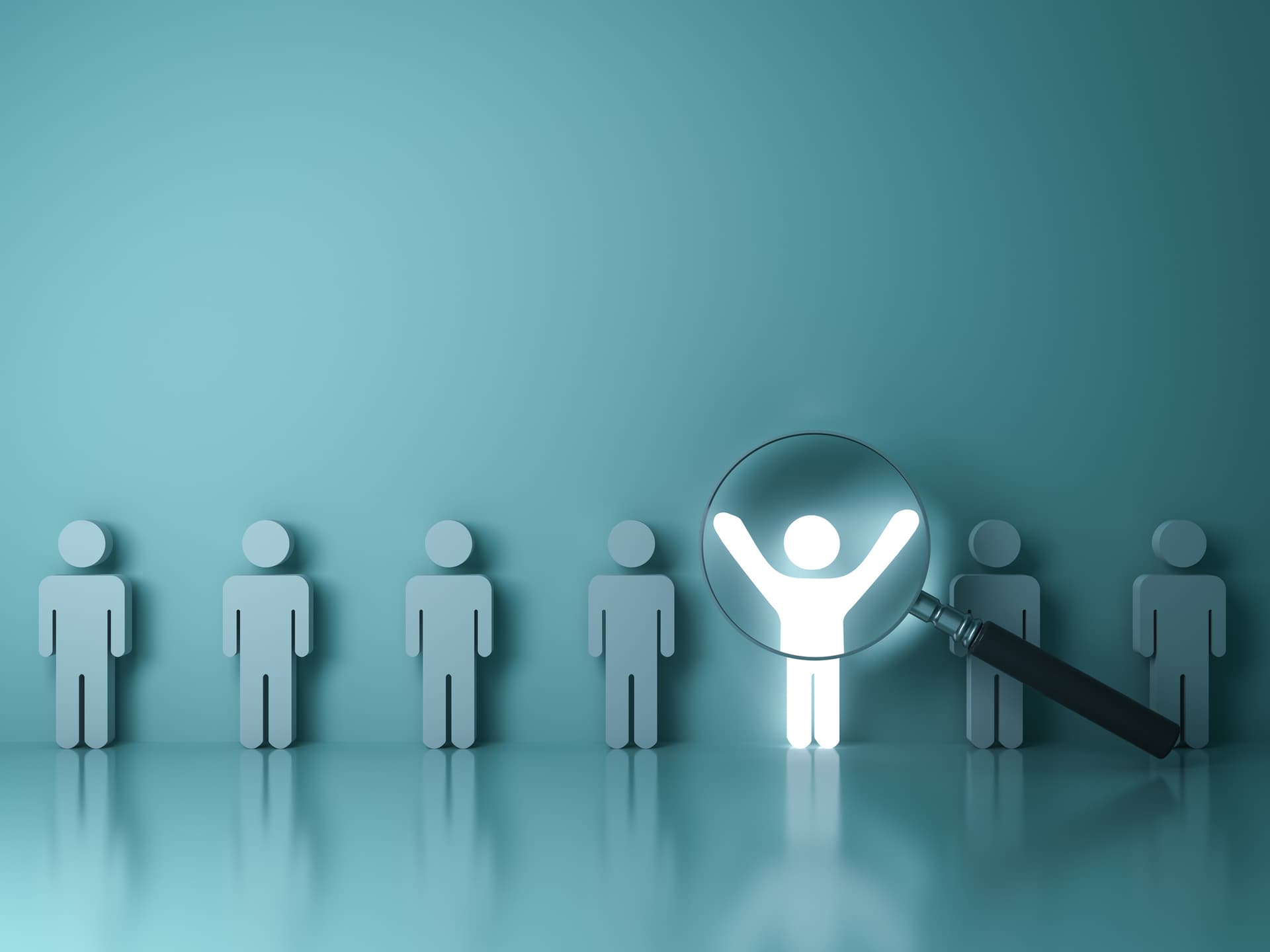 A line of stick men against a wall. One is illuminated with its arms raised as a magnifying glass hovers over it
