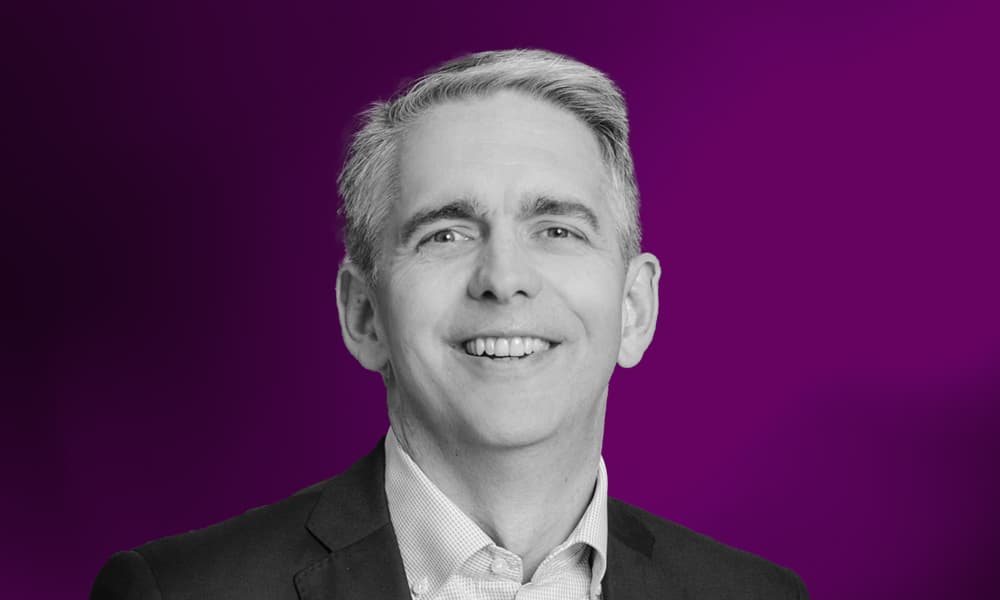 Headshot of Paul Greenwood, Pacific Current Group, against a purple background