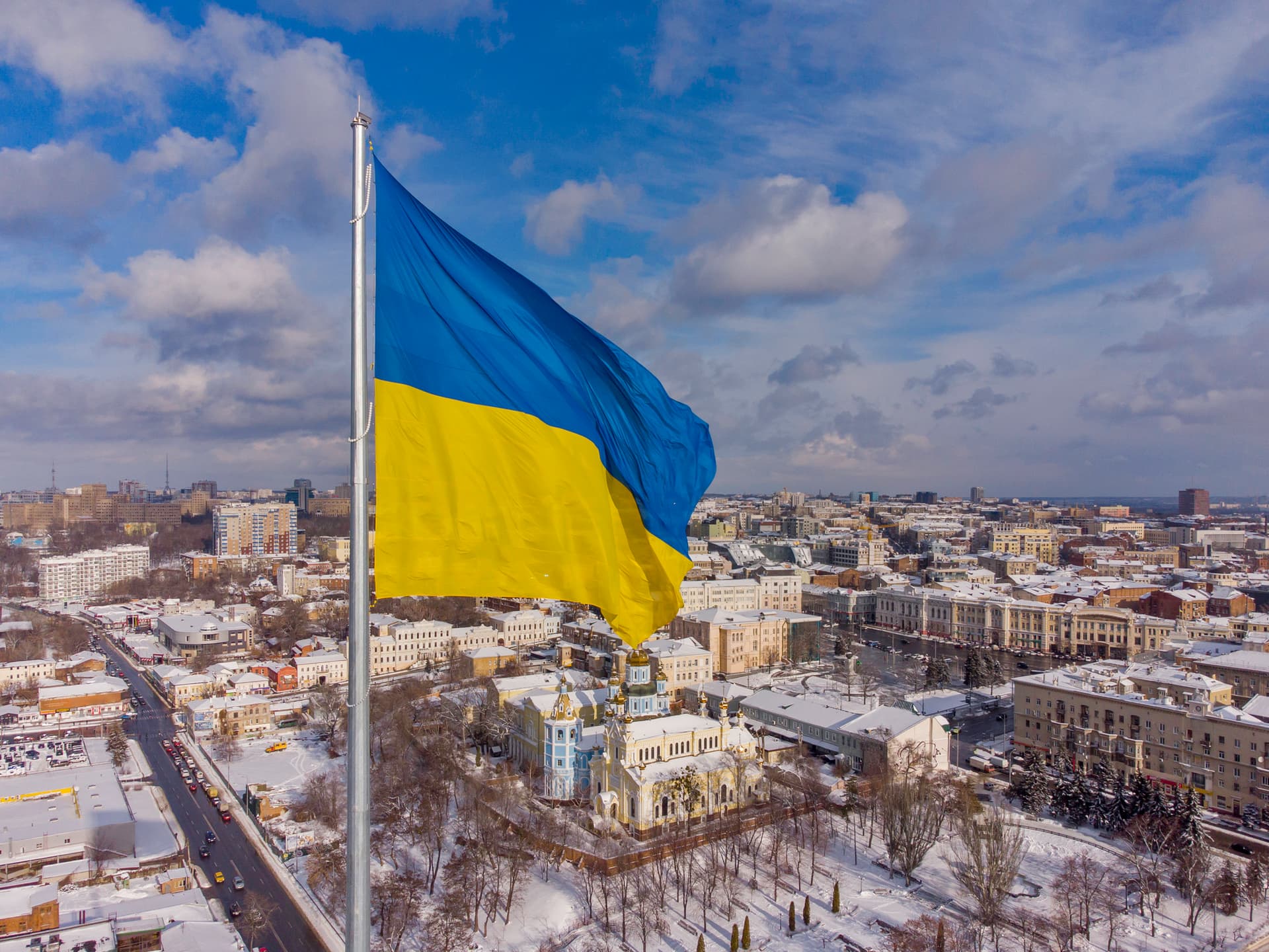 A Ukrainian flag flying over the city of Kharkov in winter