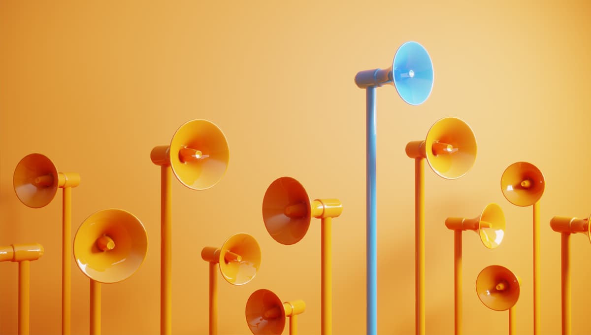 Blue colored megaphone standing out from the crowd