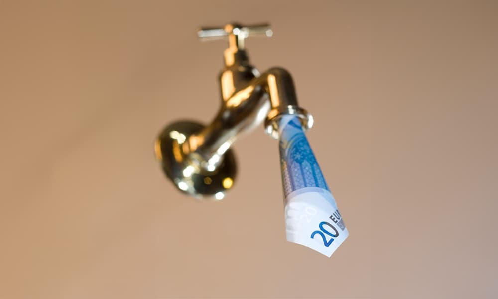 Image of a gold tap faucet leaking euro bills
