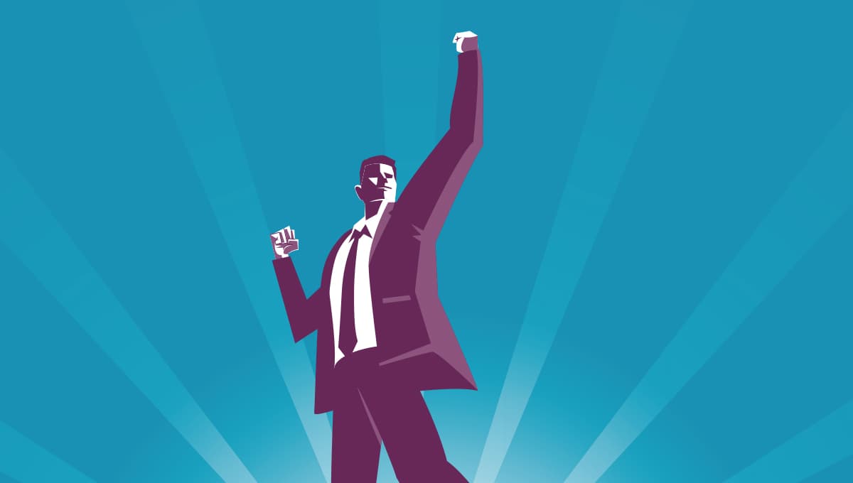 Businessman pumps the air with a fist in a strong pose
