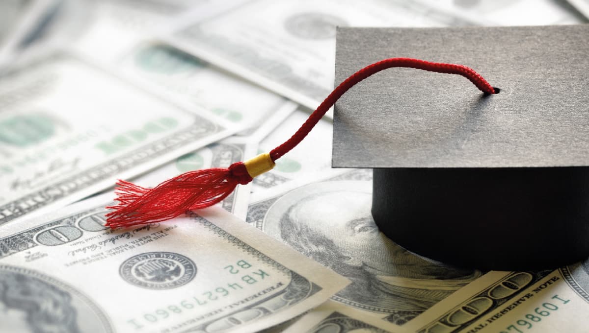 Graduation hat on dollars