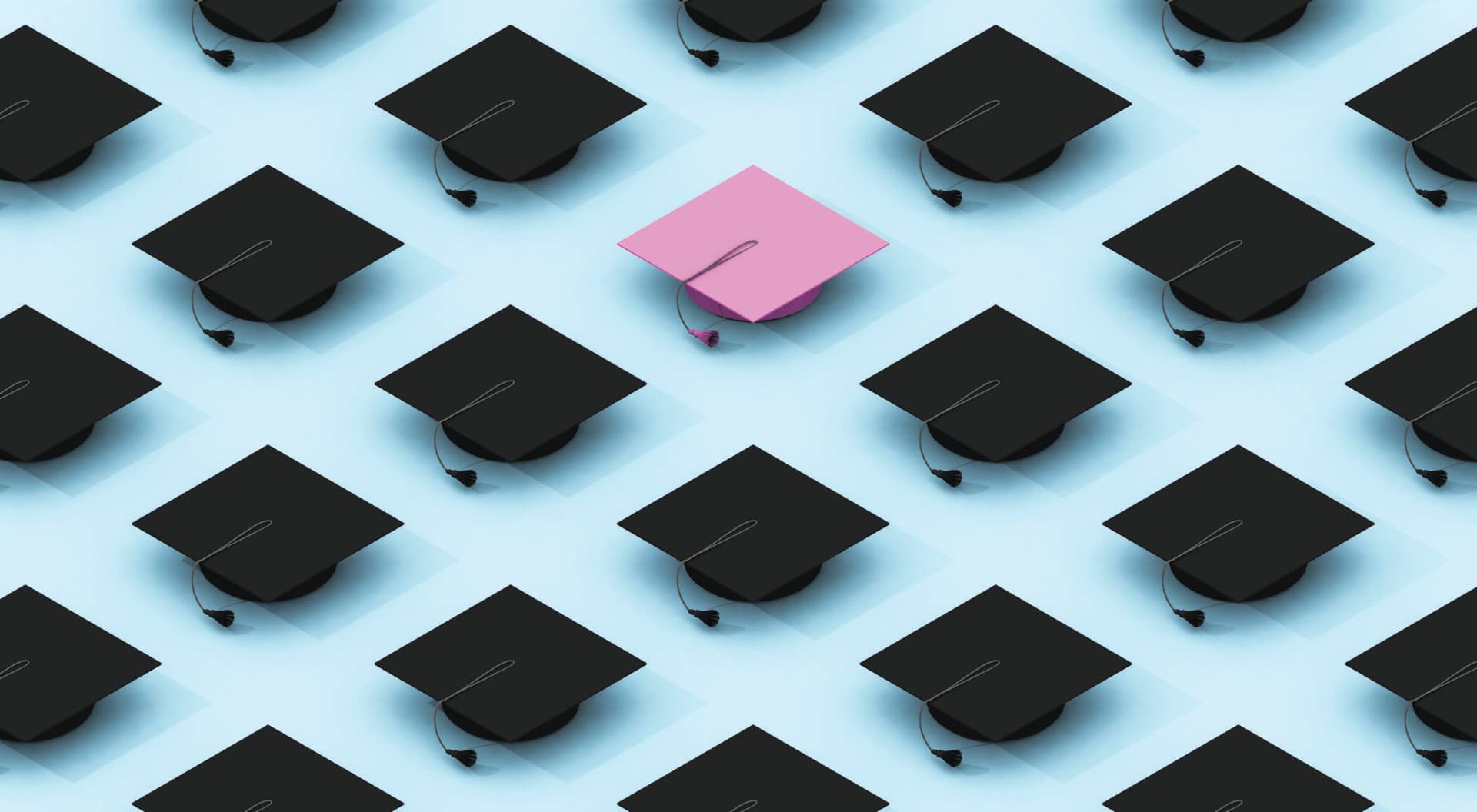 Multiple black graduation caps against a blue background, with one light purple one