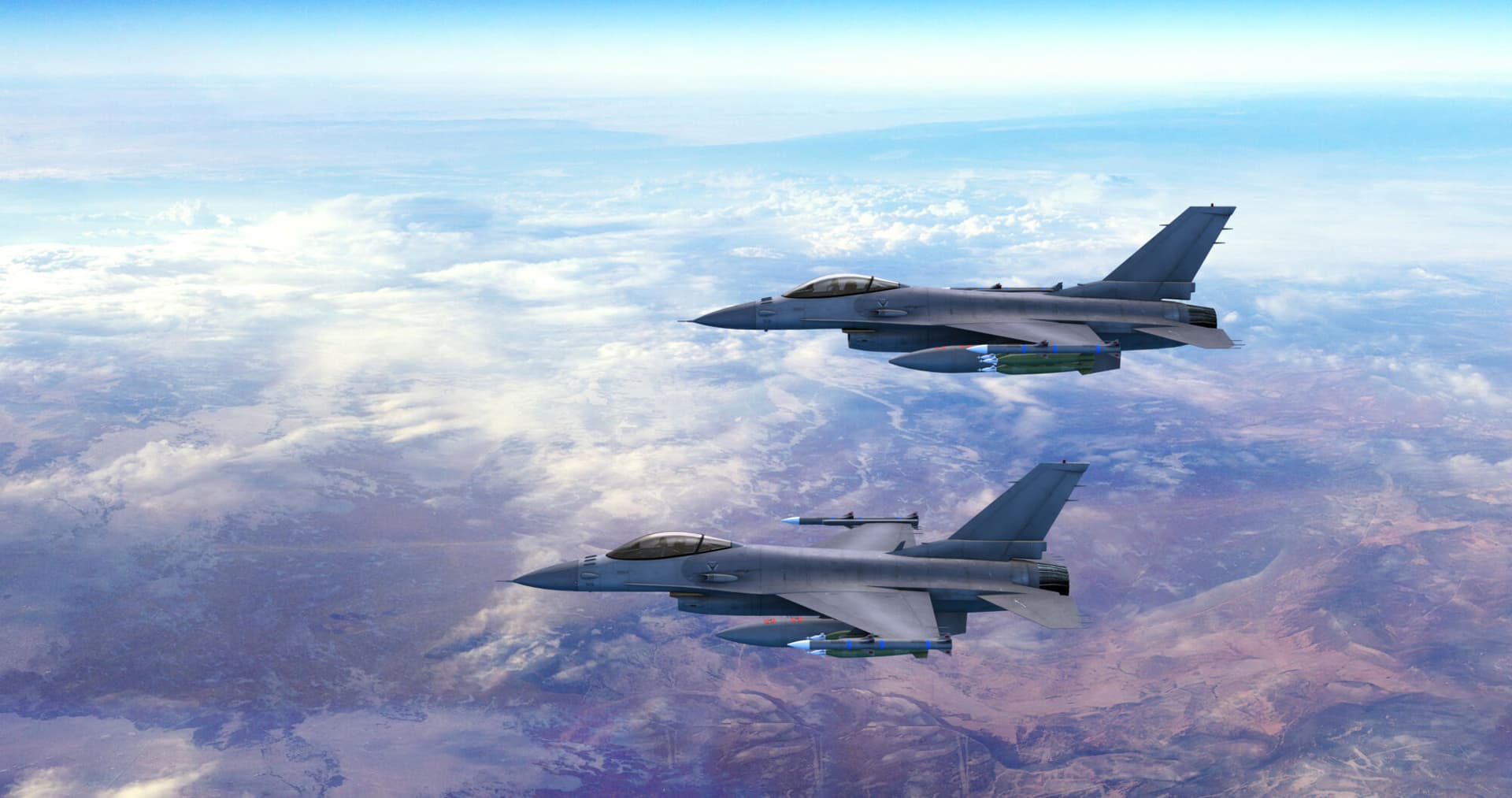 Two fighter jets flying together above clouds over Europe