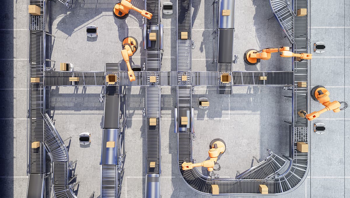 Top down view of a manufacturing facility with conveyor belts and robotic arms