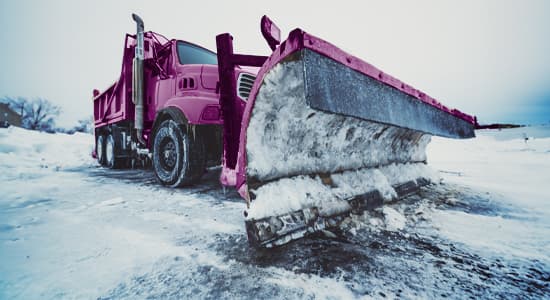 Snow plough clearing snow